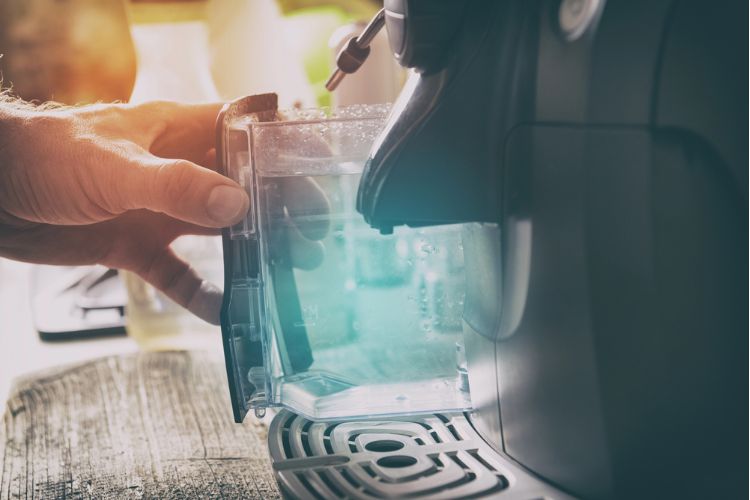 Changing water in coffee machine reservoir