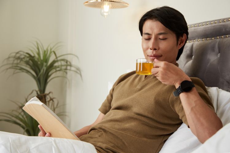 Man Drinking Tea in Bed
