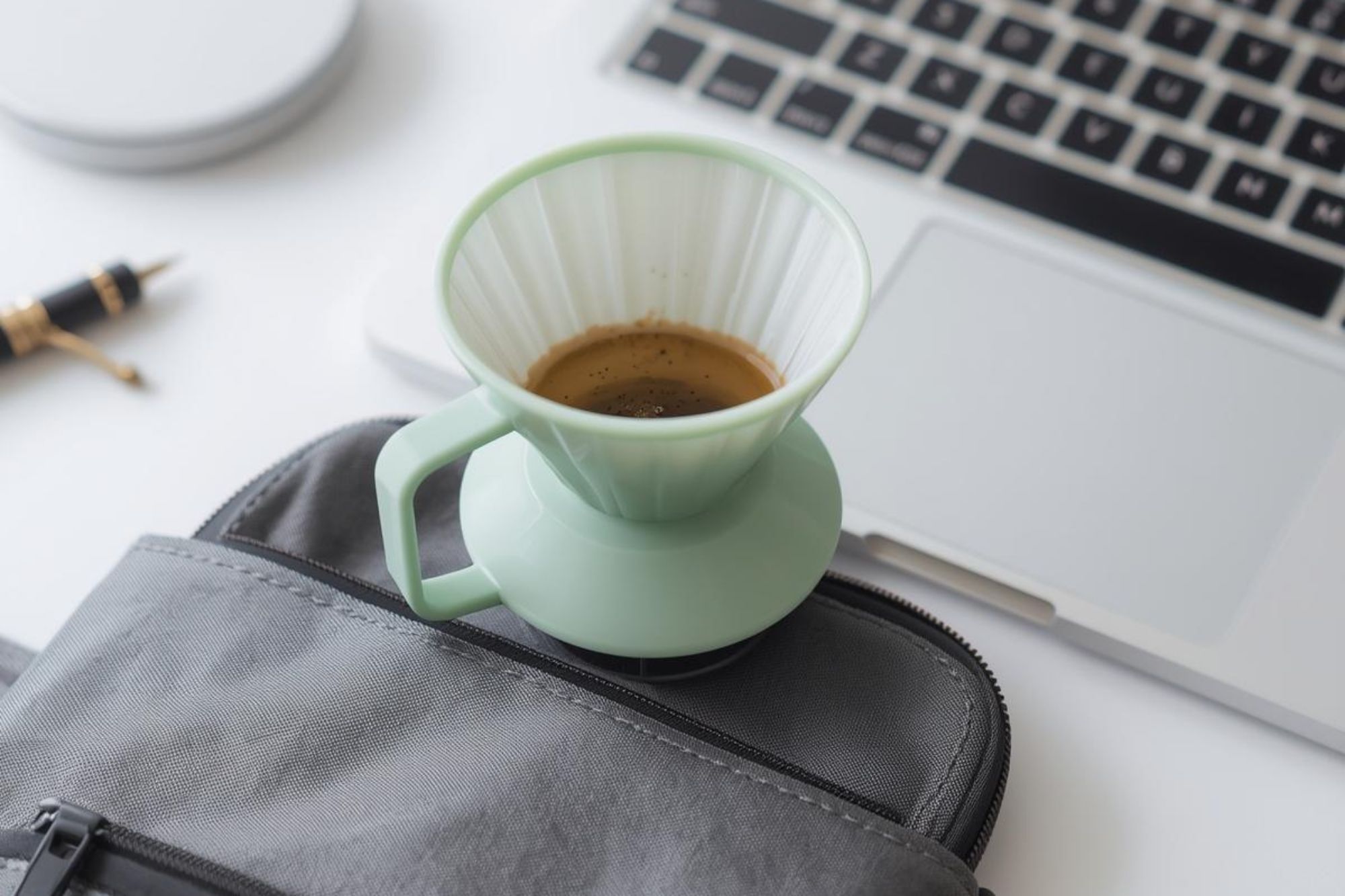 A simple, lightweight photo of a plastic V60 in a travel bag or on an office desk.