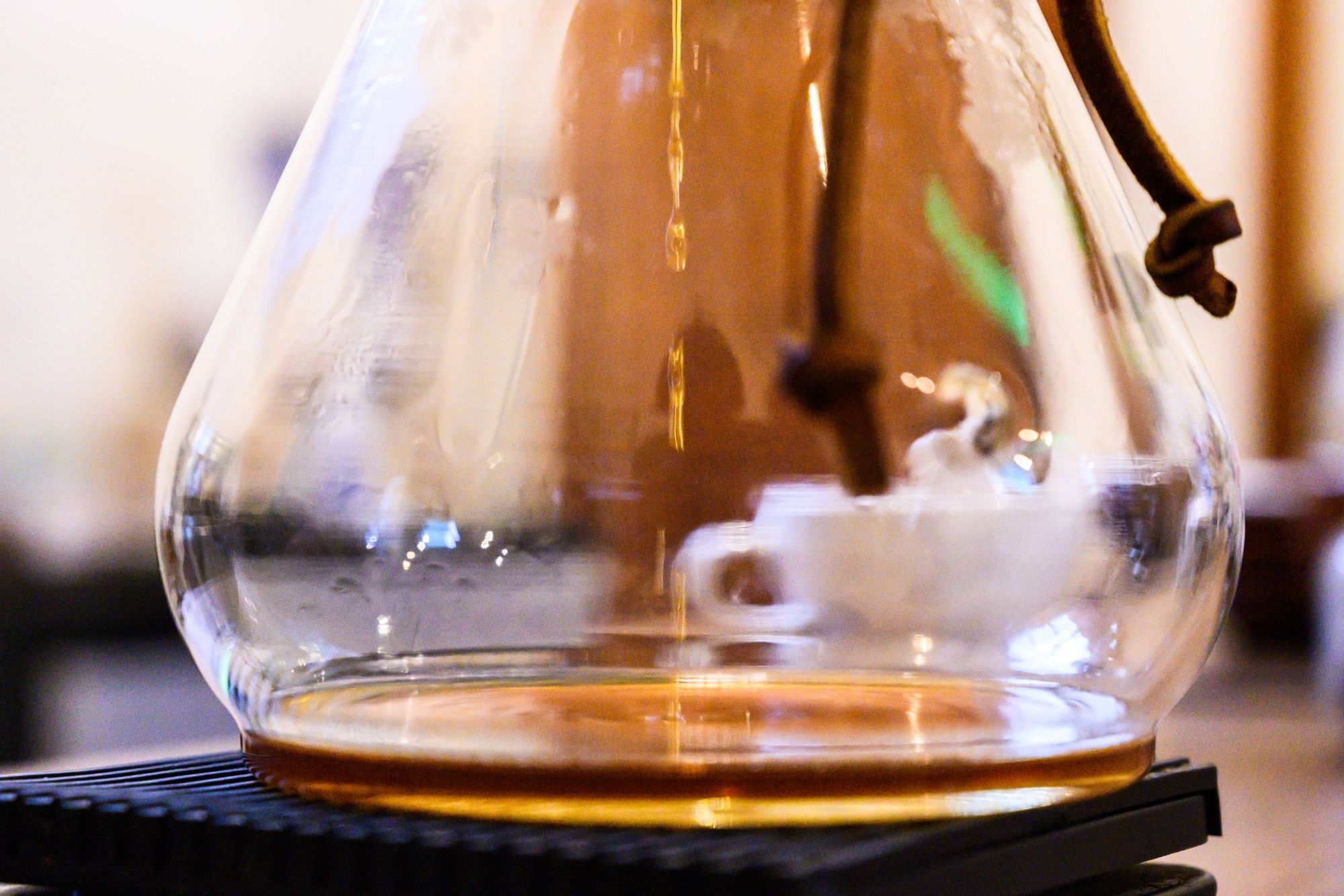 A close-up photo of the Chemex Funnex with a gentle stream of water being poured.