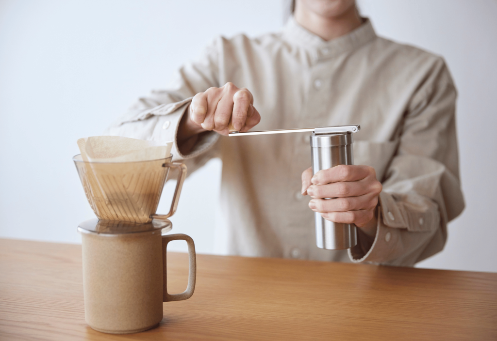 someone preparing coffee for a kalita wave dropper