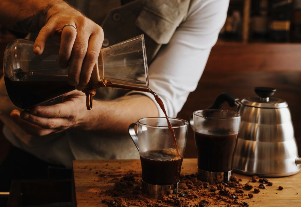 pouring coffee into a glass cup