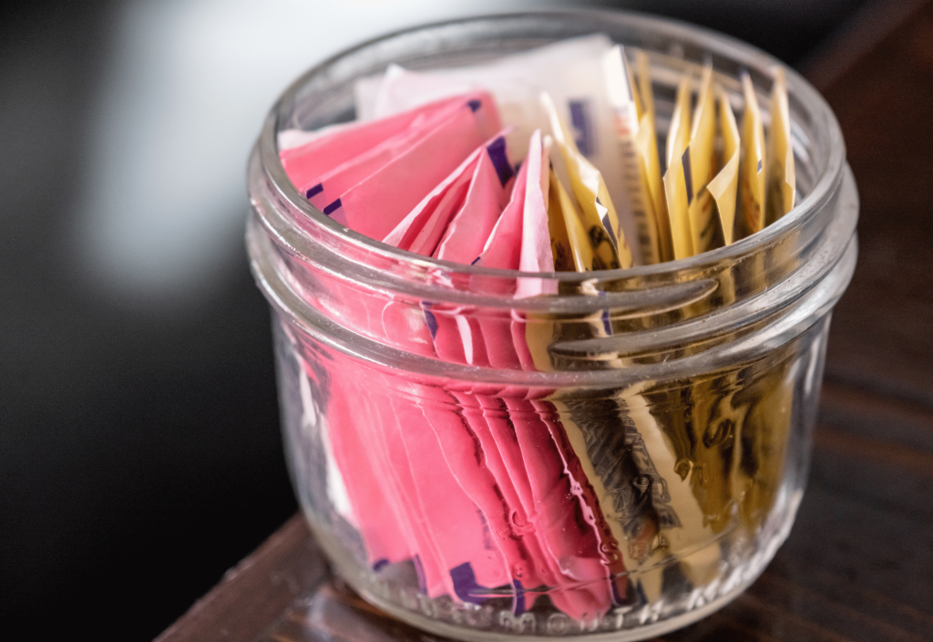 sweetener packs in a glass jar