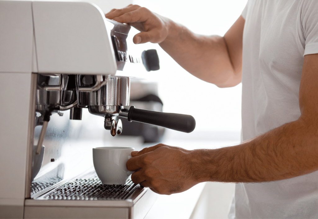 a man making coffee using an espresso machine