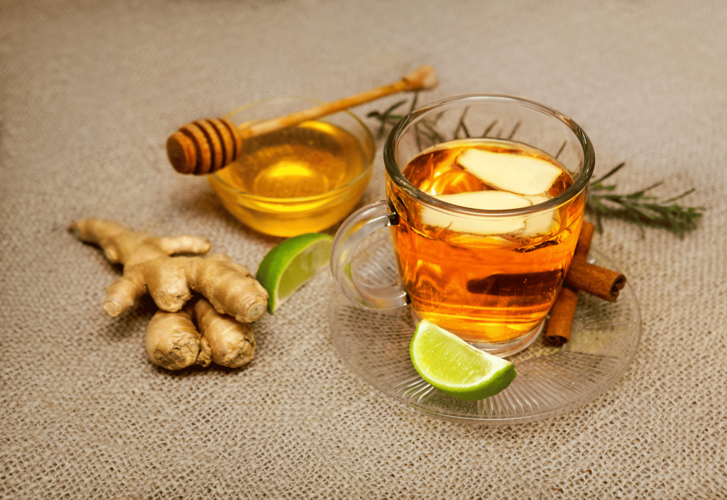 ginger cinnamon tea cup with ingredients around it